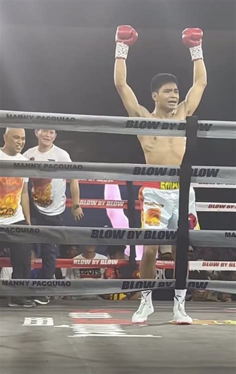 Eman Bacosa kisses Manny Pacquiao after boxing victory .